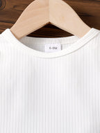 طقم مكون من قطعتين: تيشيرت بأكمام طويلة وبنطال جينز مزين بجيب على شكل قلب وفيونكة.