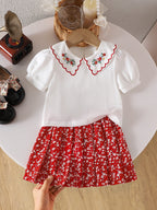 طقم صيفي مكون من قطعتين للبنات الصغيرات: بلوزة قصيرة الأكمام مطرزة بياقة بيتر بان وتنورة مطوية مزينة بالزهور